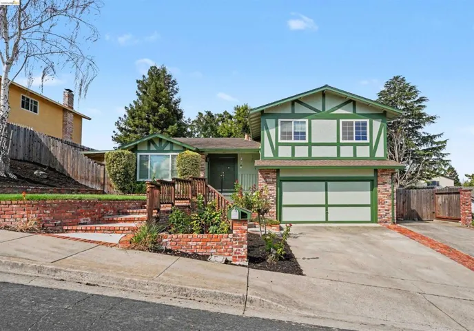 Tudor-style exterior with green trim and white siding