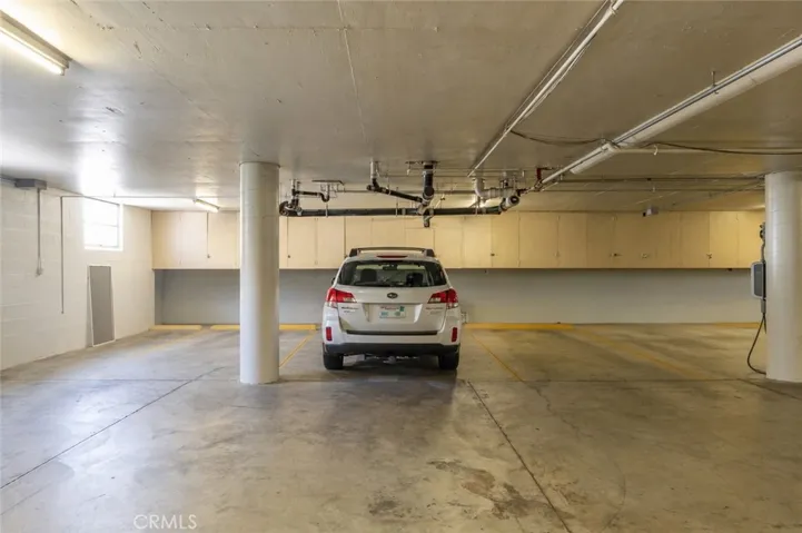 1 of 2 parking spaces. This one with storage. Digitally altered to remove other vehicles
