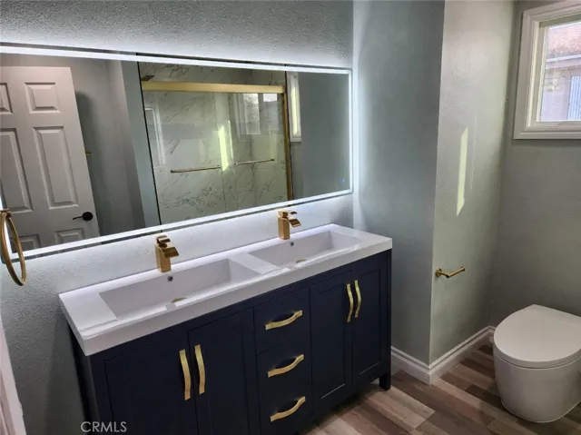 2nd guest bathroom with fogless mirrors and light , double sinks, high end toliet & shower/tub