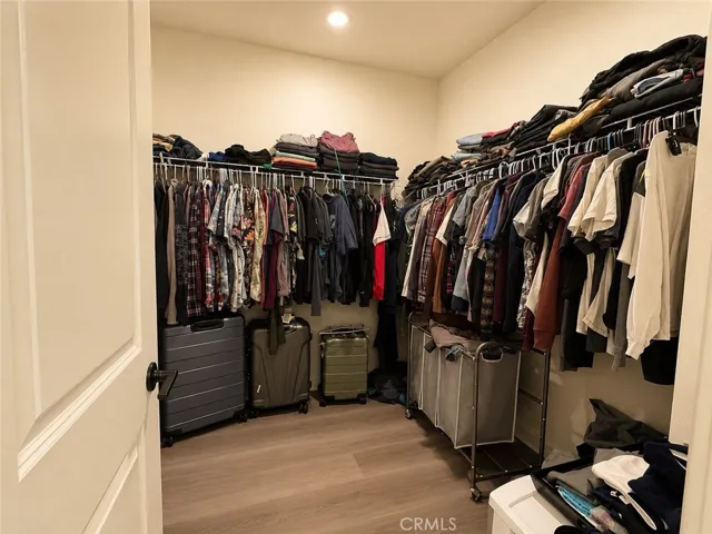 Primary bedroom walk in closet