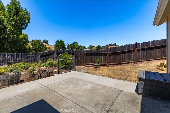 Backyard patio, yard and fenced garden backs up to open space very private.