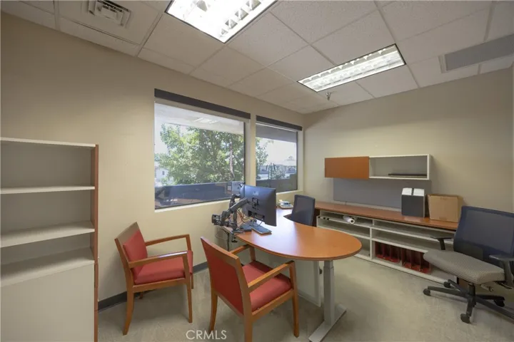 One of the bright, professional upper-level office spaces featuring a clean layout, private workspace, and scenic window views.