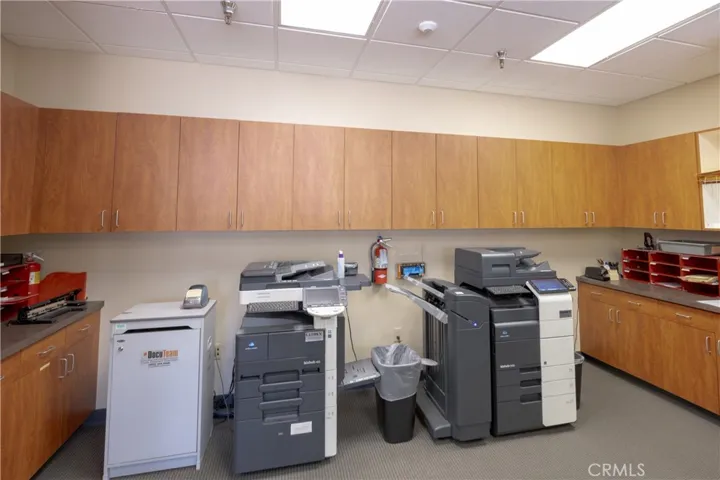 Upper-level office or flex space, currently configured as an open-concept copy room.