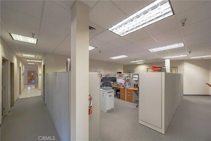 View of the office cubicle space located in the center of the lower level, positioned between the two hallways.