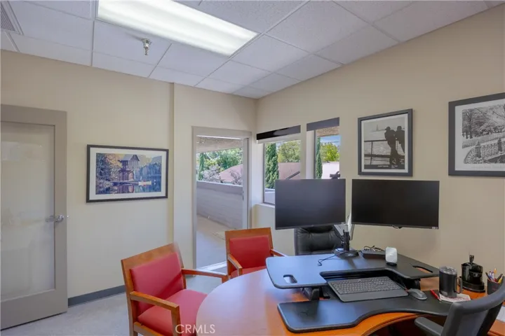 Spacious corner office featuring scenic views of Bishop Peak and direct access to a private balcony.