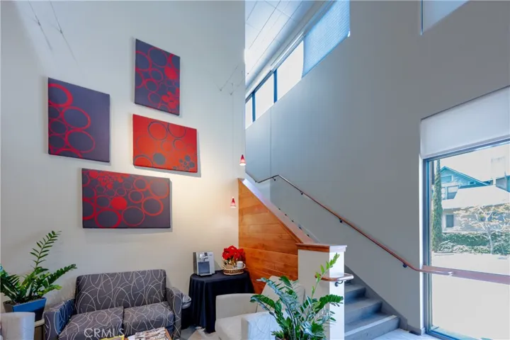 Spacious lobby featuring a wide carpeted staircase leading to the upper level.