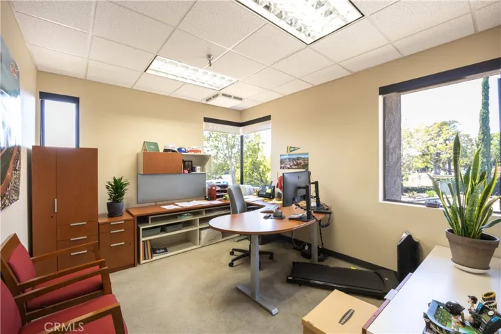 One of the private corner offices featuring ample natural light and a functional layout, perfect for professional use.