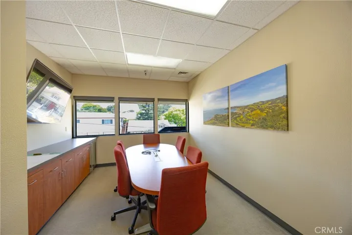 Secondary conference room located mid-hallway on the upper level.