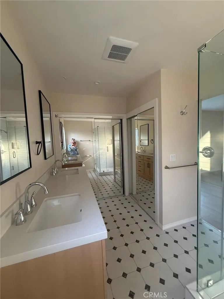 Master bath with his and her sinks plus his and her closet
