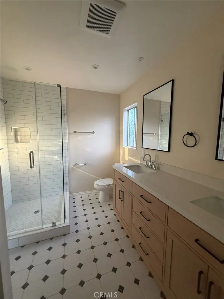 Master bath shower, toilet, and double sink