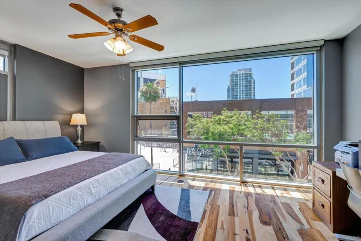Such a spacious primary bedroom! Floor to ceiling windows. Stunning views to start and end your day! Hardwood flooring throughout!