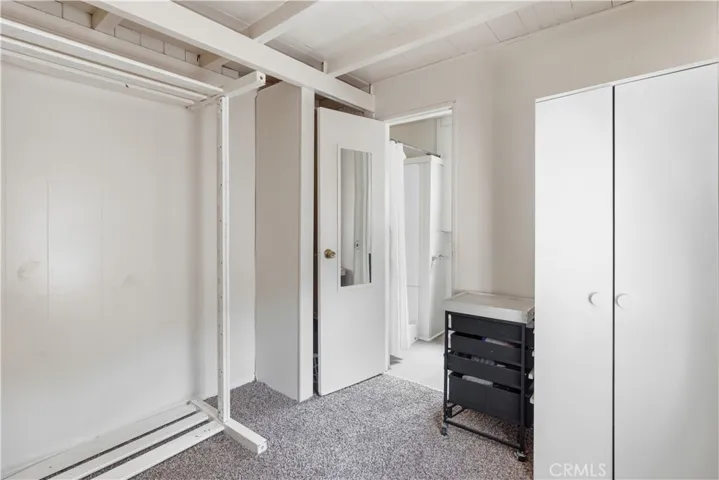 bedroom with bathroom door open