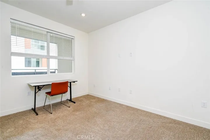 The original living room is now an additional office space on the second floor. The balcony is right outside of the window.