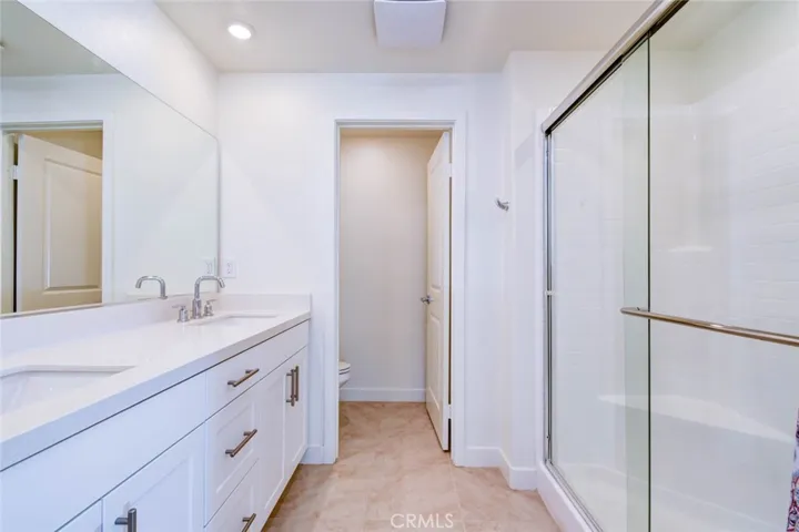 The primary bathroom on the third floor has dual vanities and walk-in shower.