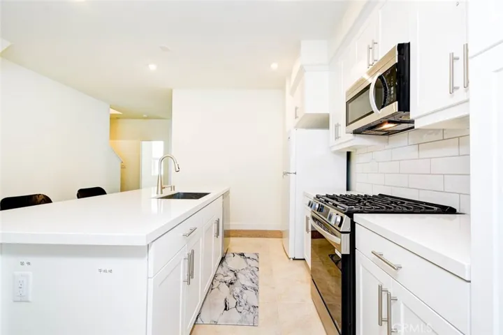 Another view of the kitchen and kitchen island.