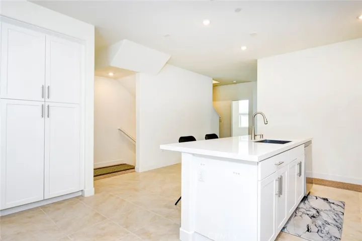 The kitchen and the dining area is located on the second floor. The kitchen has an island with stainless steal sink and dishwasher. The pantry on the left side provide ample storage space.