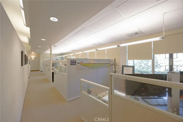 Cubicle work space with ample natural light from exterior patio/walkway