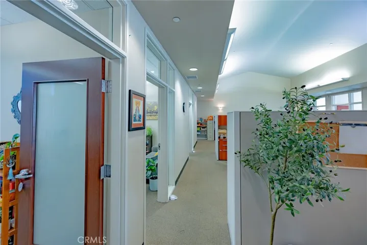 Hallway in Ste B with private offices on the right, open work space on the left