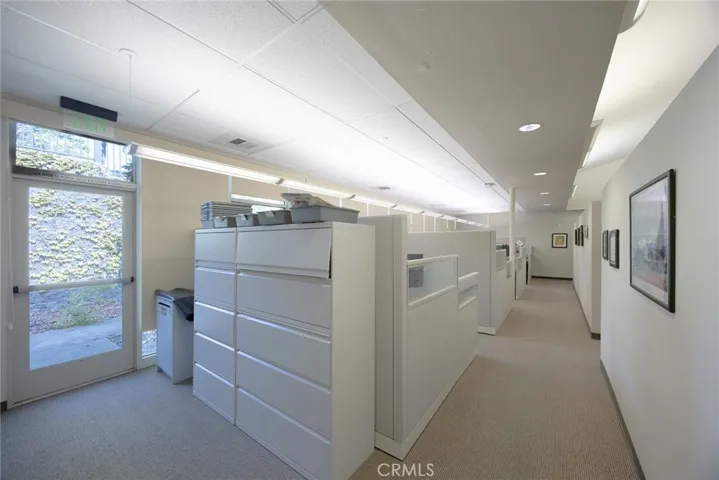 West wing hallway with cubicles on the left