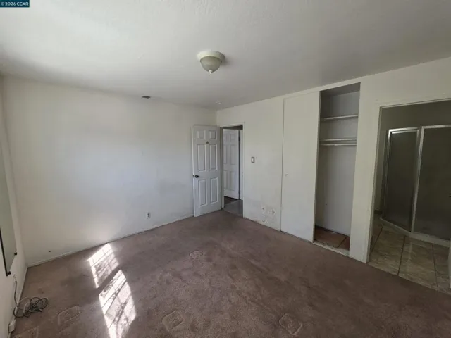 The primary bedroom has its own bathroom with a toilet and shower.