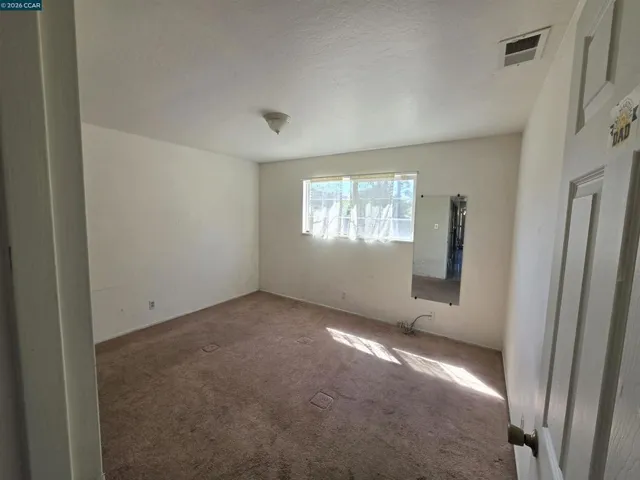 Primary bedroom. The window overlooks the backyard.