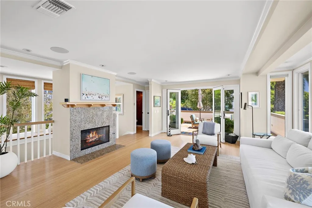 Living room with gas fireplace with granite surround.