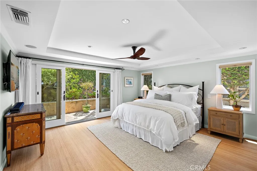 Primary suite offering private outdoor access with a walk-in closet and en-suite bath.
