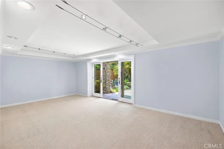 Second guest bedroom (has been digitally altered to remove the current office furniture). Bedroom has an en-suite bath and access to the backyard.
