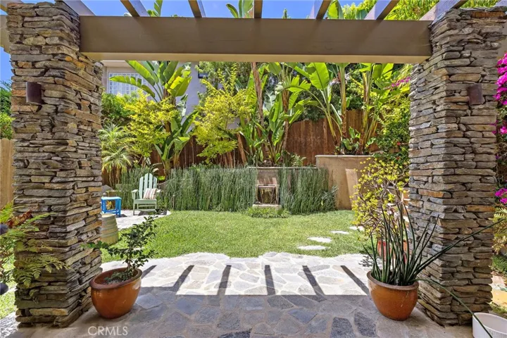 The fully fenced grassy backyard provides a rare expanse of usable outdoor space.