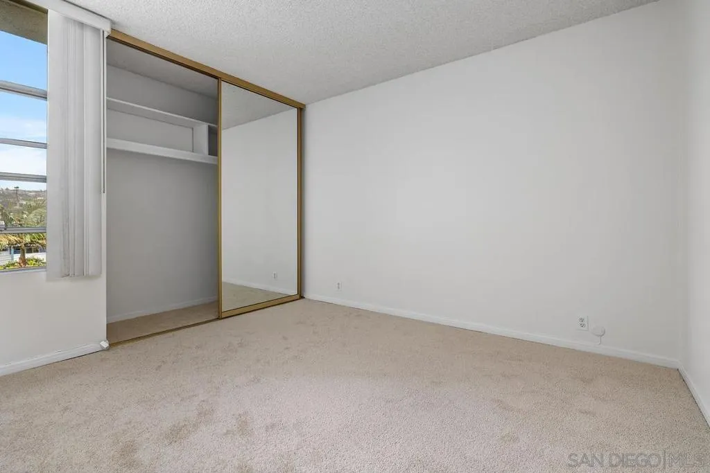 The nice sized second bedroom with fresh paint, new carpet, and ample closet space.