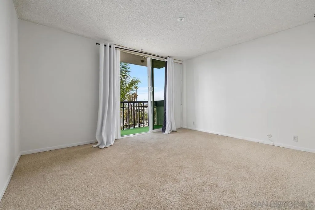 Looking across the Primary Bedroom from the hall to the slider with a private balcony to enjoy the views!!!