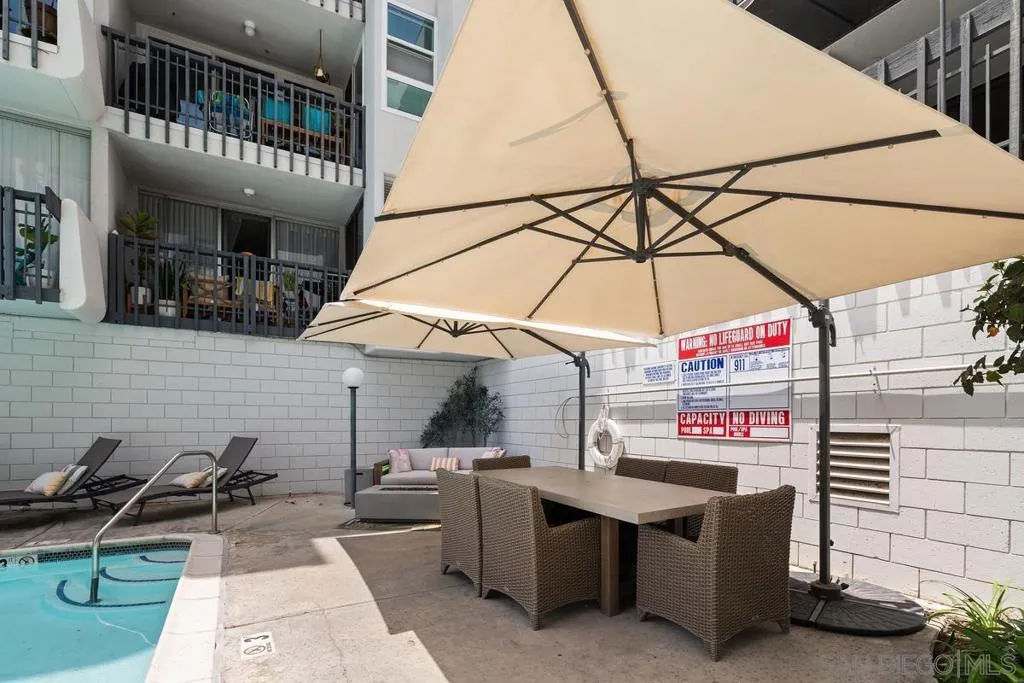 There is a large table under the umbrella and also a fire pit out by the pool.