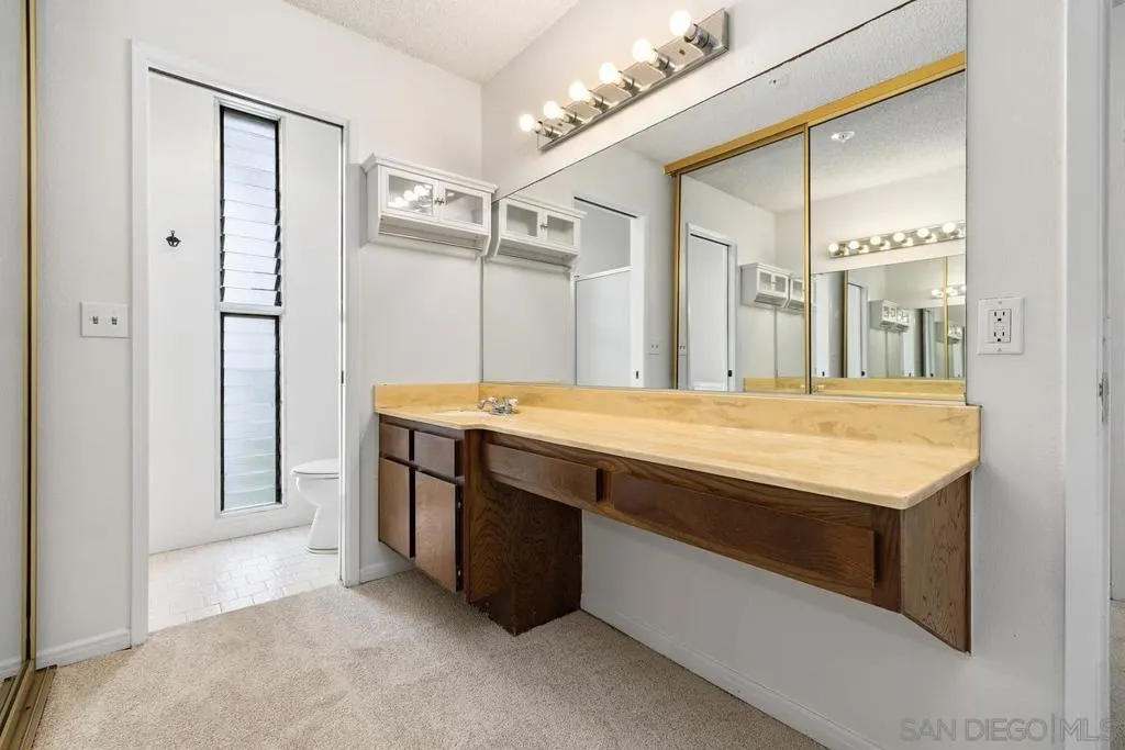 Looking across the Primary Bathroom with the huge vanity & the bathroom at the end.