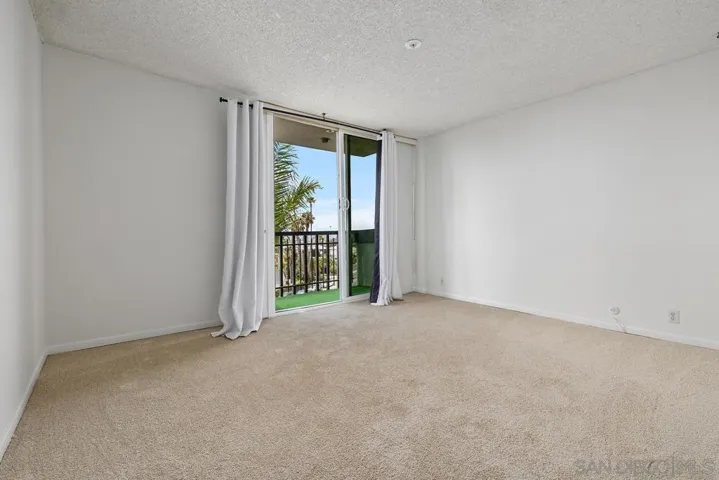 Looking across the Primary Bedroom from the hall to the slider with a private balcony to enjoy the views!!!