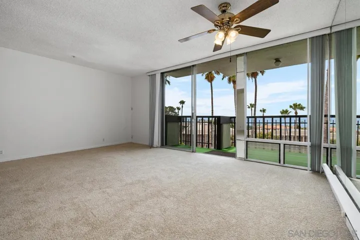 Standing at the hall in front of the kitchen, looking across the dining area with a ceiling fan, the view just does not go away!!!