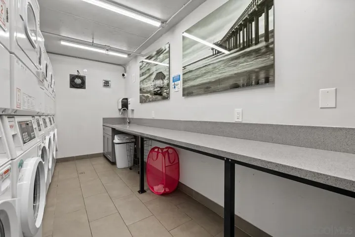 The laundry room has a long folding table.