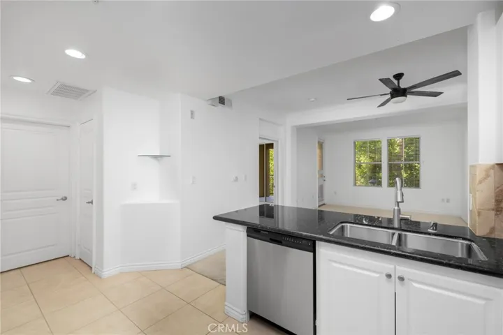 Thoughtfully designed kitchen features timeless white shaker cabinetry, low-maintenance quartz countertops, and stainless steel appliances.