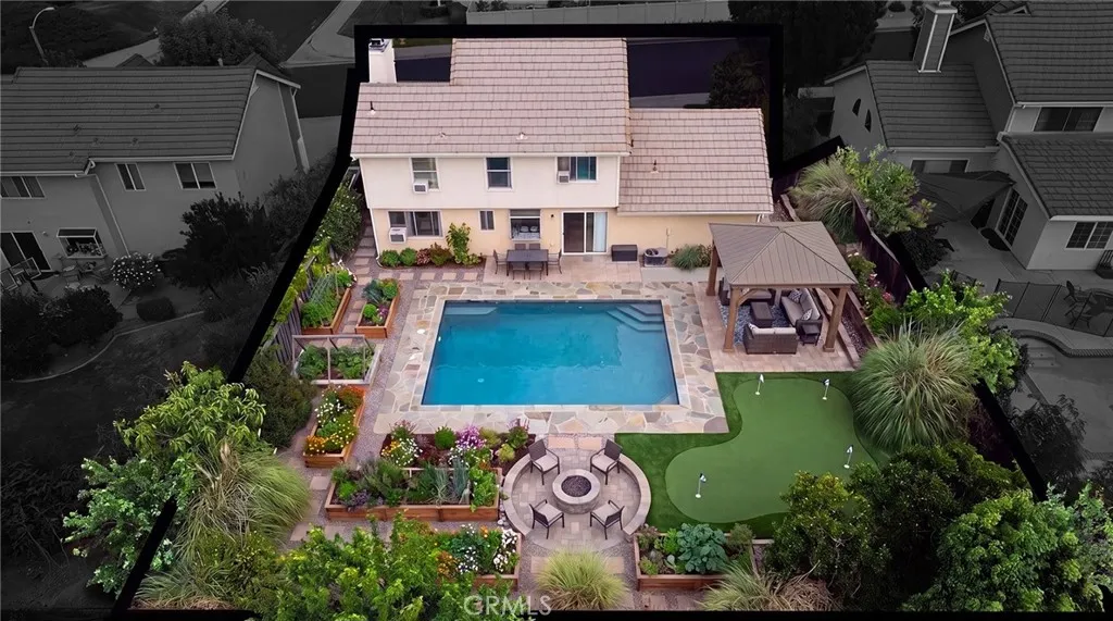 Virtually altered image. Pool, landscaping, hardscape, gazebo, putting green, and other backyard improvements shown are conceptual and do not currently exist.