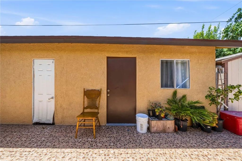 Garage door (white) and Studio unit entrance (brown)