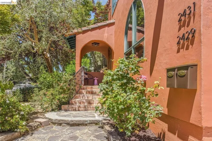 Beautiful terra cotta stucco and a covered porch with arches add to the Mediterranean feeling of 2431 McKinley