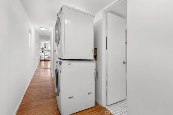 Stackable washer & dryer in hallway.