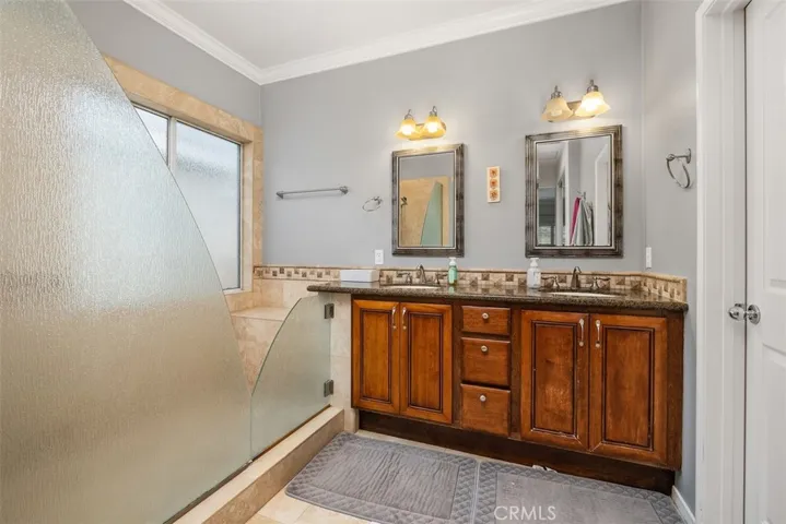 The primary bathroom has been upgraded with a large walk-in shower and double vanity