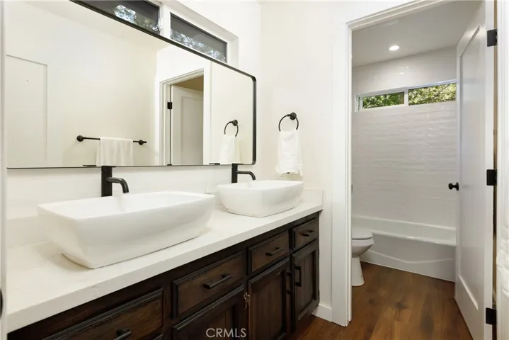 Bathroom, double sinks and more transom windows.