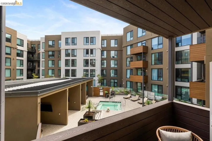 Balcony featuring view of pool