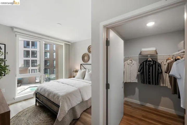 Bedroom with wood finished floors and baseboards