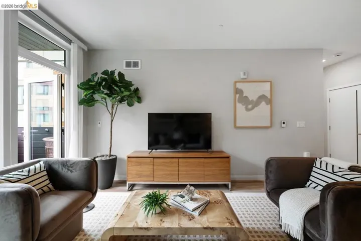 Living area with baseboards and wood finished floors