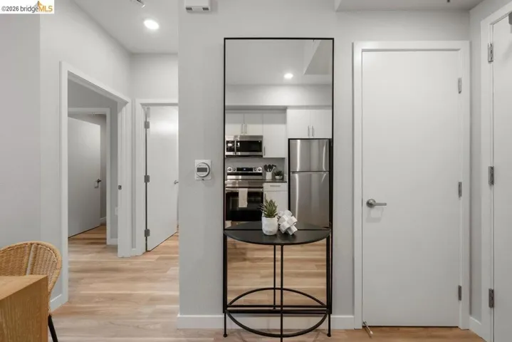 Corridor featuring light wood-style floors and baseboards