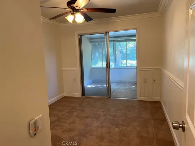 Bedroom 2 is carpeted and there is an enclosed patio room perfect for a small office or craft room. Smooth ceiling, crown molding and a ceiling fan.