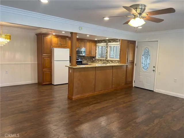 Beautifully upgraded kitchen with new microwave, glass top range, dishwasher, refrigerator and granite countertops,