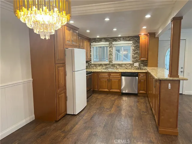 Enjoy plenty of light in this kitchen with lots of recessed lights and oh so many lovely cabinets.
